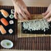 Imagem de uma pessoa montando um sushi