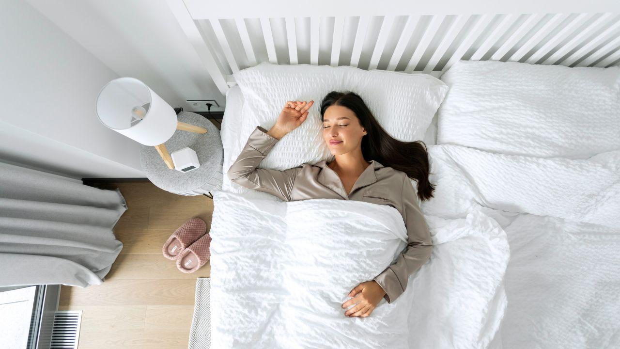 Imagem de uma mulher deitada de costas na cama