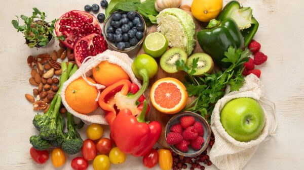 Foto mostra várias frutas, legumes em cima de uma mesa.